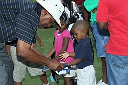 Jim Dent shows the golf grip to the next generation of golfers at the African American Golfers Hall of Fame Golf Clinic, May 29, 2010.